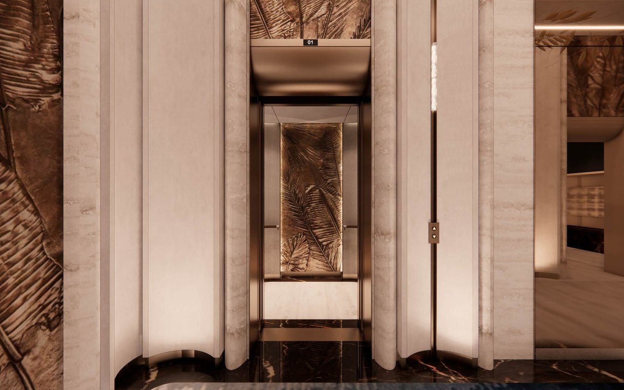 Elevator lobby with bronze doors, pale stone walls, and dark palm-patterned panels.