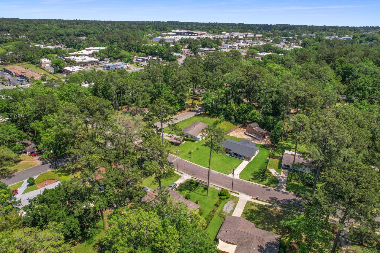 An aerial view highlighting a residential section of Town and Country, showing houses, lawns, and tree-lined streets.