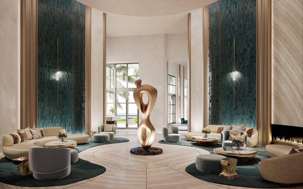 Luxury lobby lounge with teal tile walls, cream seating, and a sculptural centerpiece.