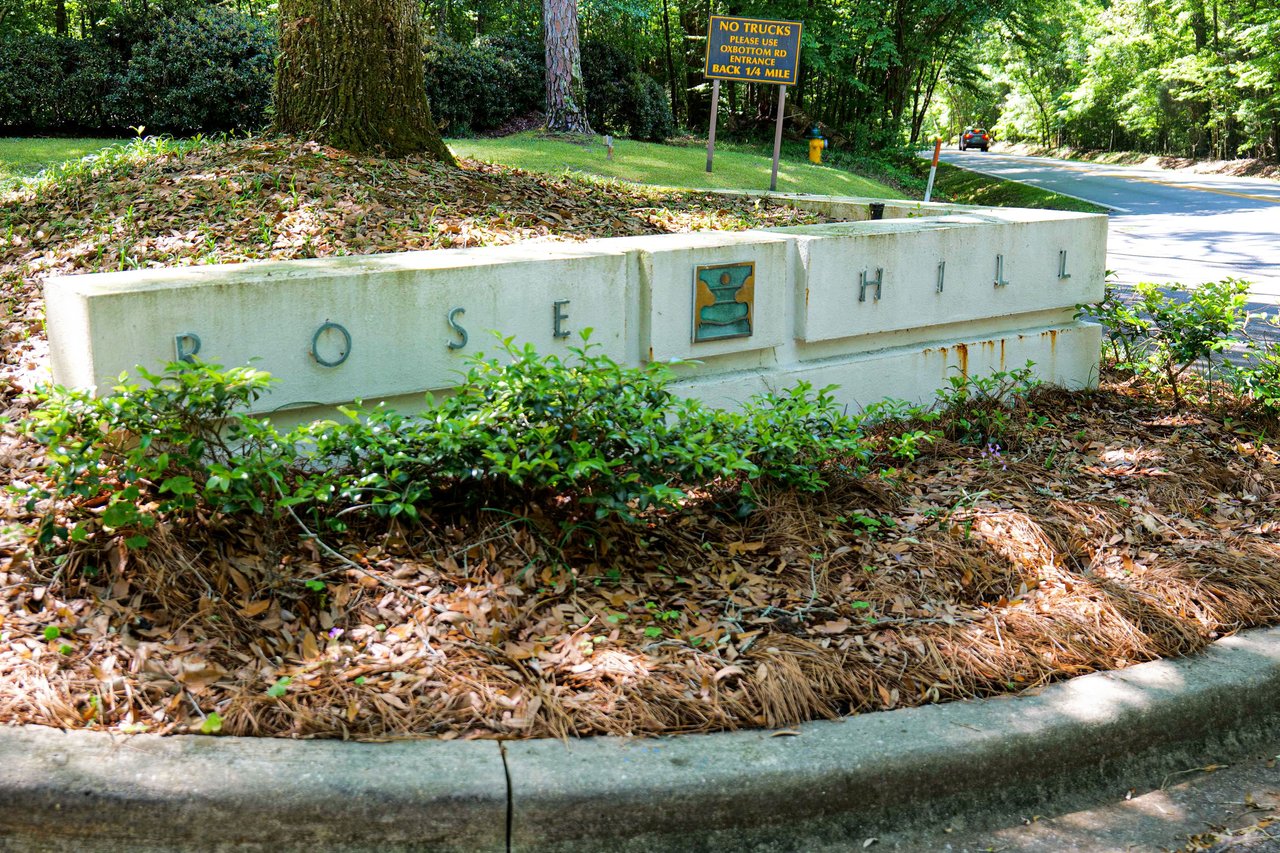 A ground-level view of the entrance sign for "Rosehill," indicating the name of the residential community.