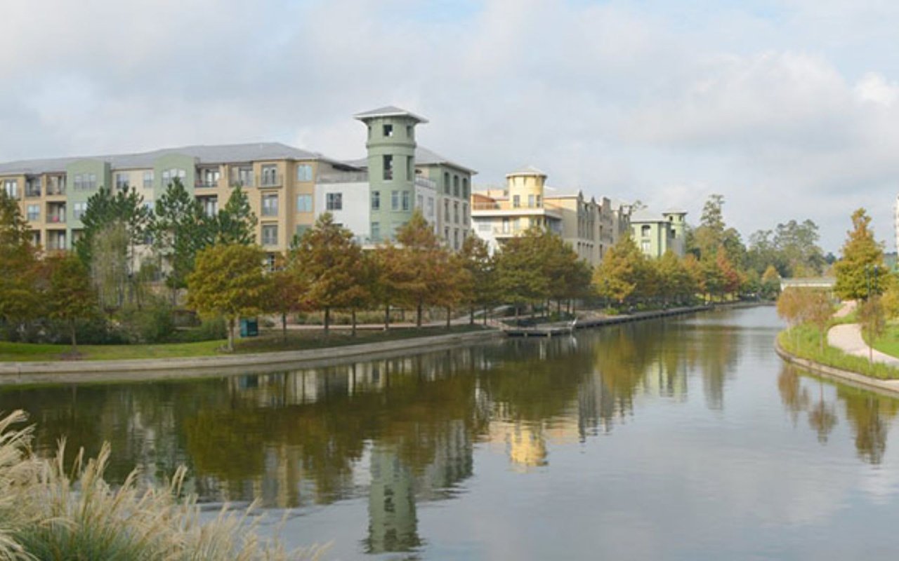  A calm canal winds through an urban landscape