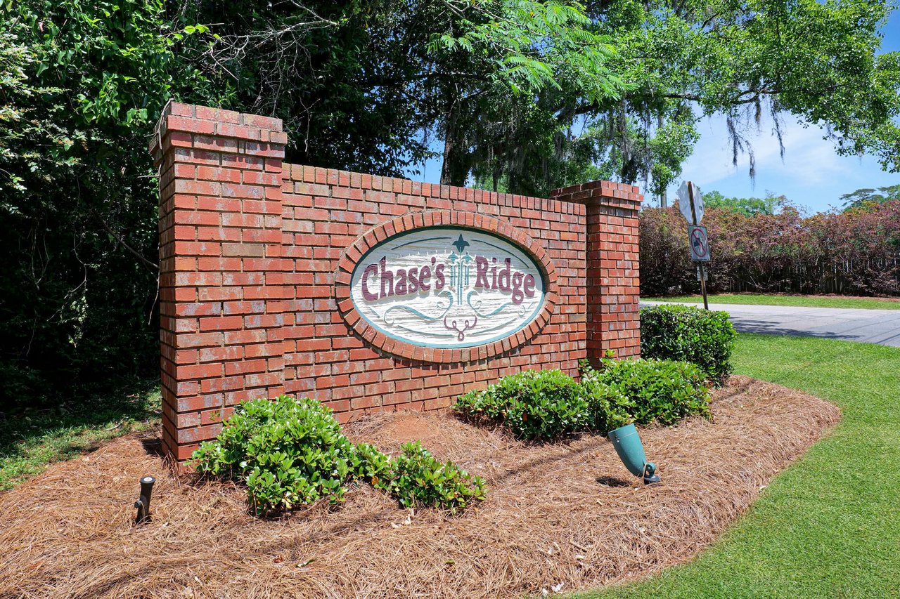 A ground-level view of the entrance sign for "Chases Ridge," indicating the name of the residential community.