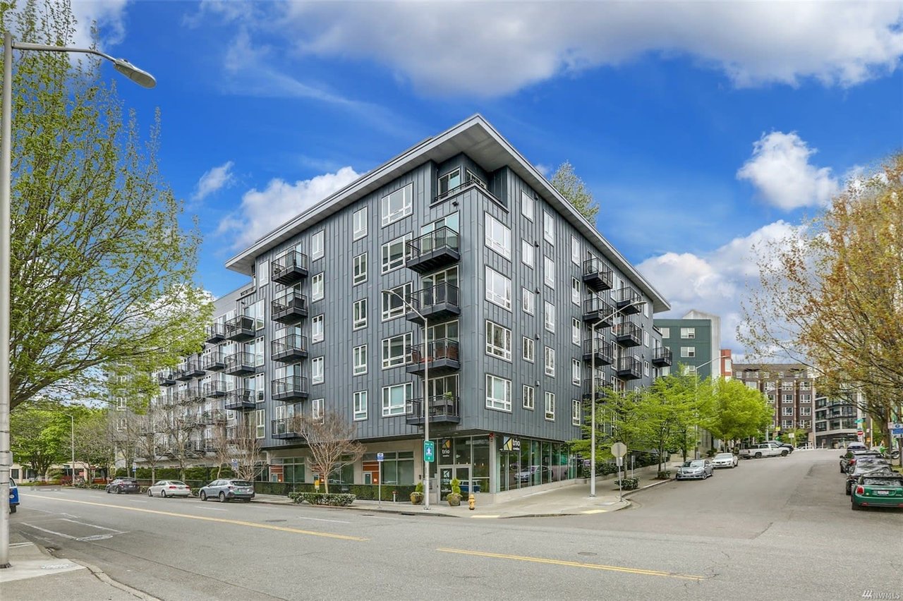 Modern urban condo with spacious balconies on a bright day, offering a blend of comfort and luxury in the city.