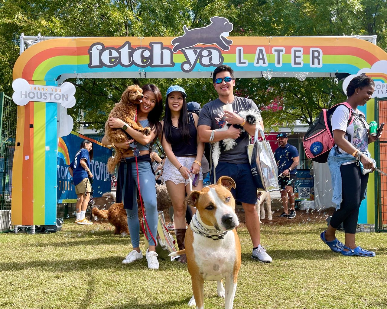 Dog-friendly activities in Houston: Raquel Refuerzo at Discovery Green Puptopia Festival with adorable dogs