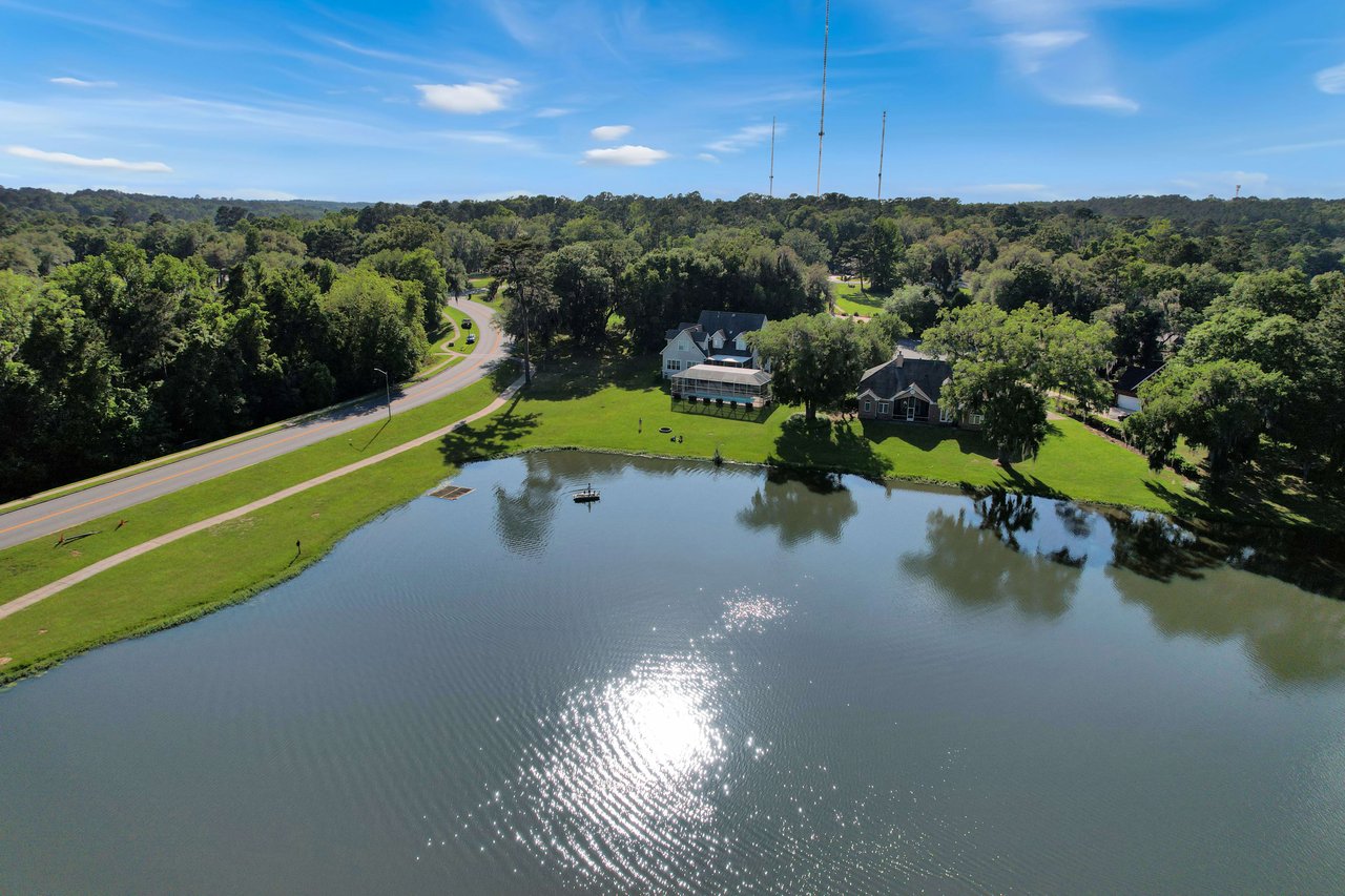 An aerial view of a lake within the Summerbrooke community, surrounded by houses and trees.