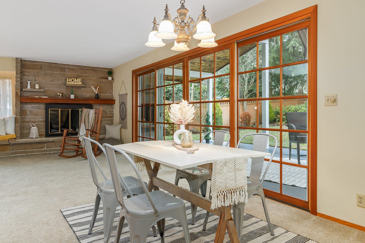 This dining area seamlessly opens to a covered patio and a beautiful private backyard, offering a perfect blend of indoor-outdoor living for your enjoyment.