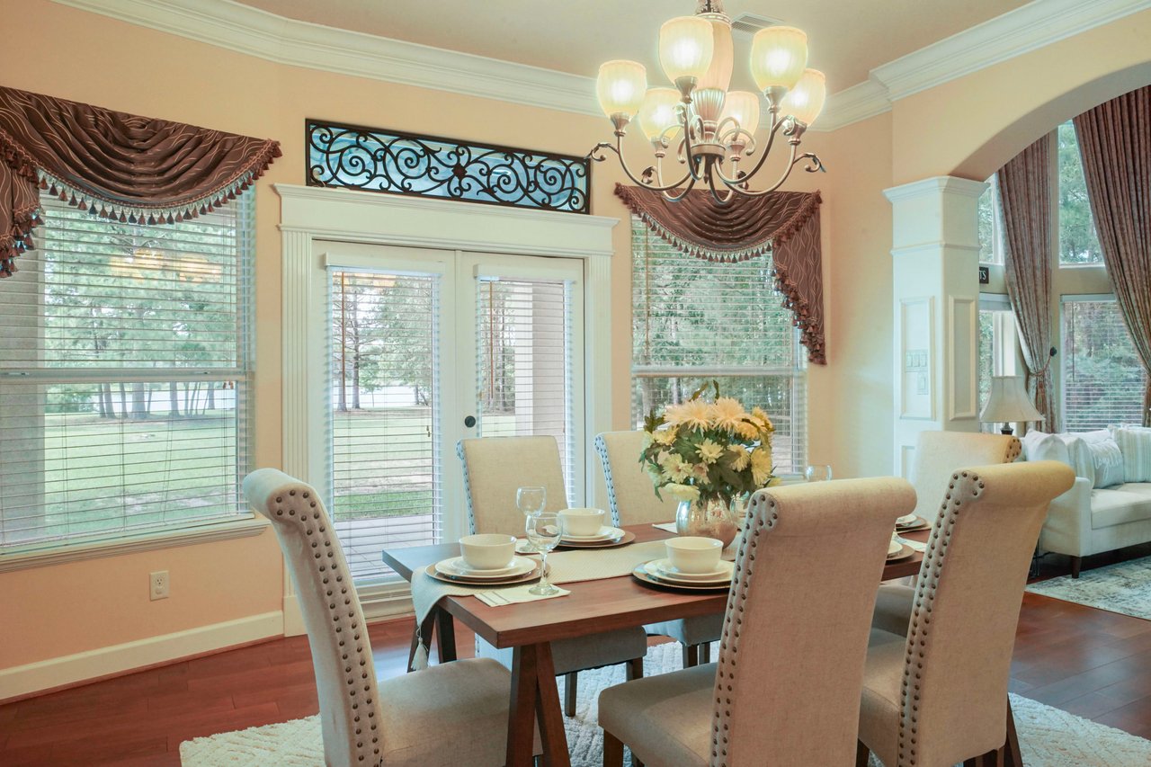 The LAKE VIEW! Note the custom details throughout the home: 8" ceiling molding, picture frame and crown molding trimmed columns, and the iron scroll transom window.