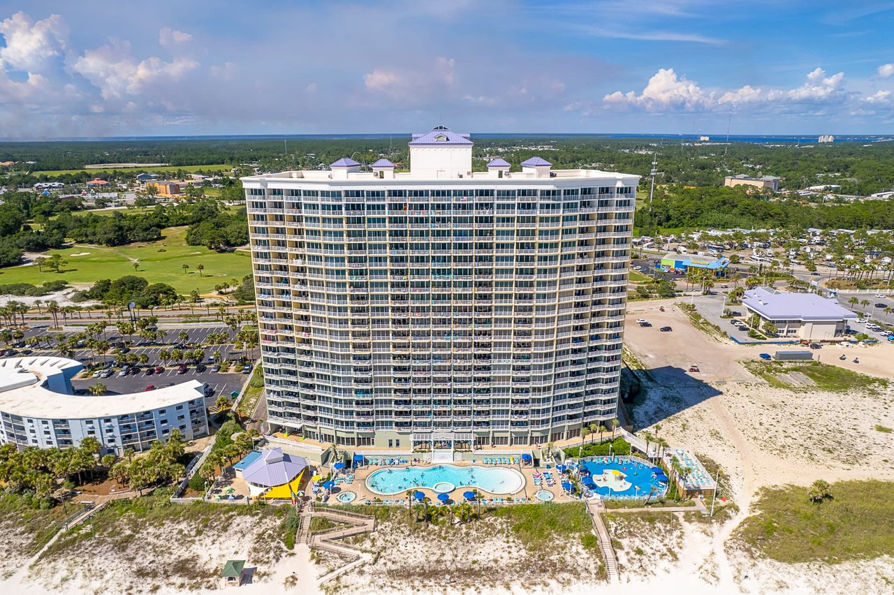 An aerial view of the Panama City Beach high-rise Boardwalk condominium building, pool and beach access points.