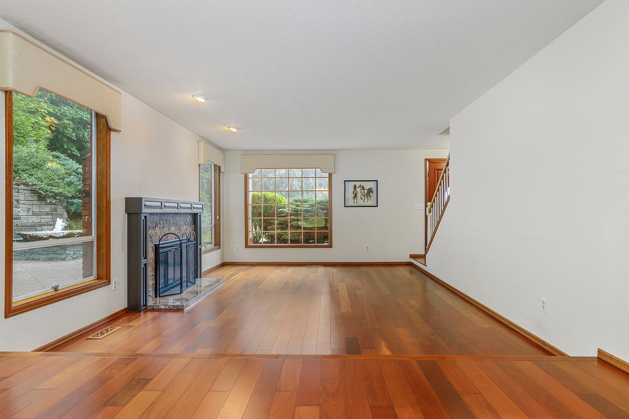 Admire the serenity of the formal living room's huge windows, offering picturesque views of the tranquil fountain outside. It's a space where elegance meets nature, creating a truly enchanting atmosphere.