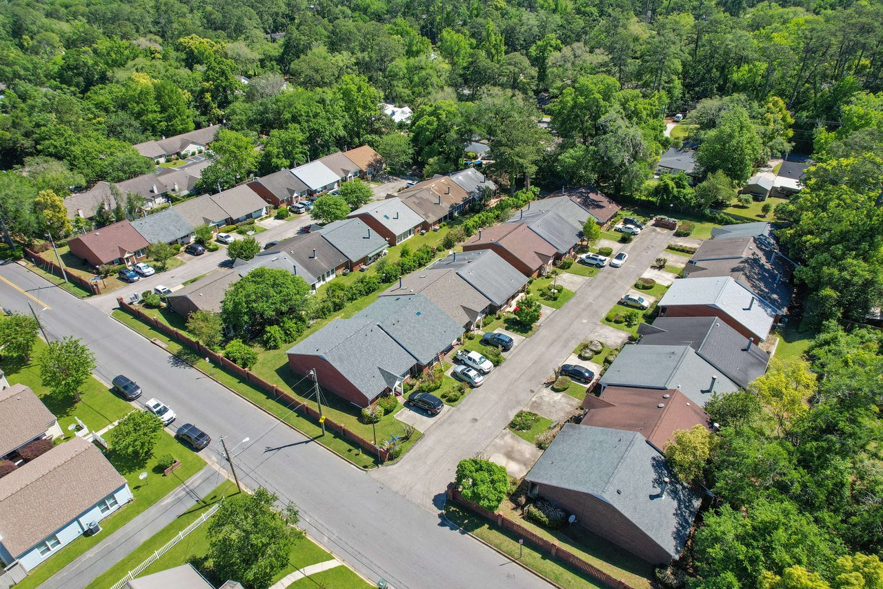 An aerial view of a residential area in Terrace Park with multiple houses and streets, surrounded by trees.