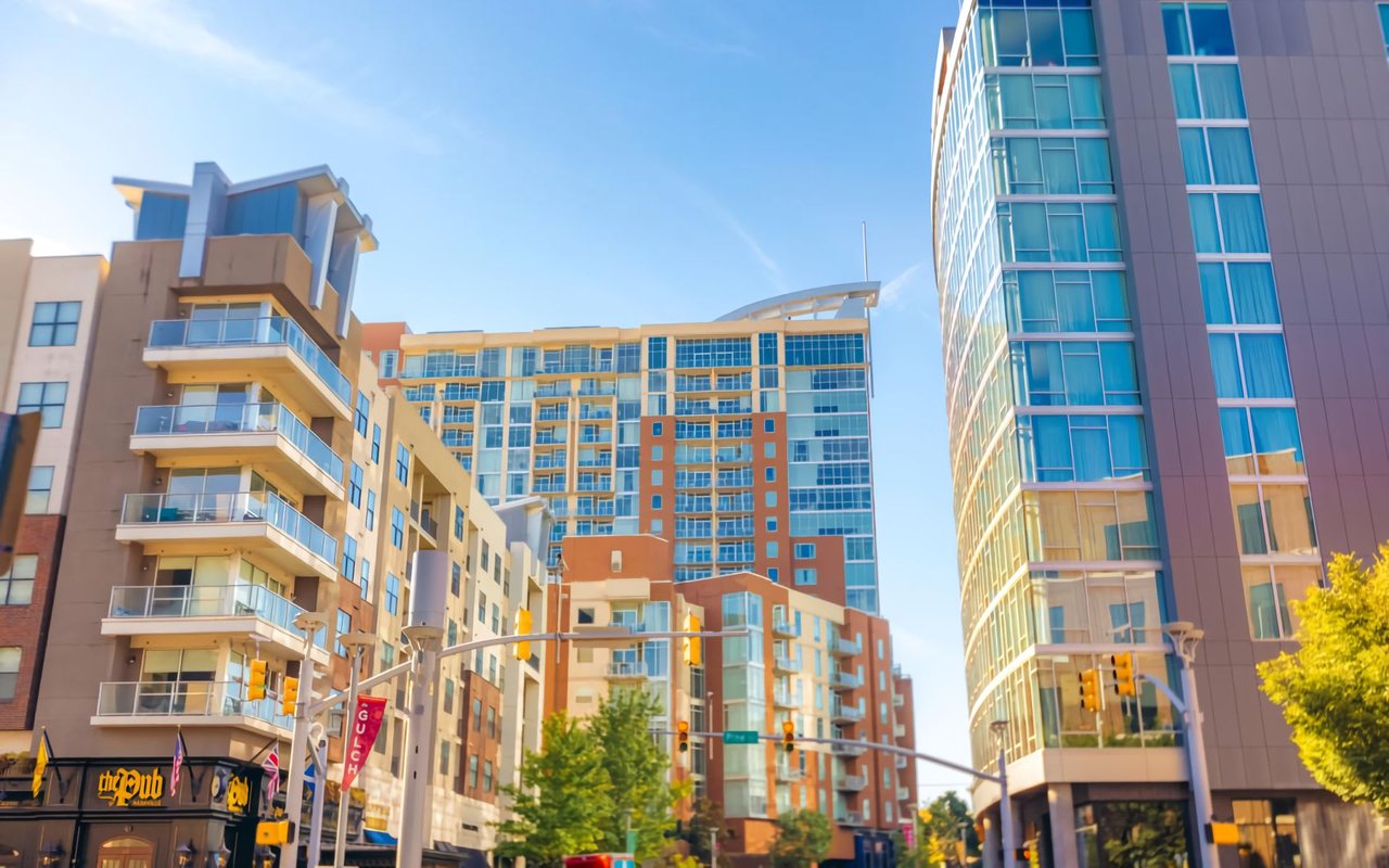 Modern glass high-rises in The Gulch, Nashville, with sleek designs and rooftop terraces. 