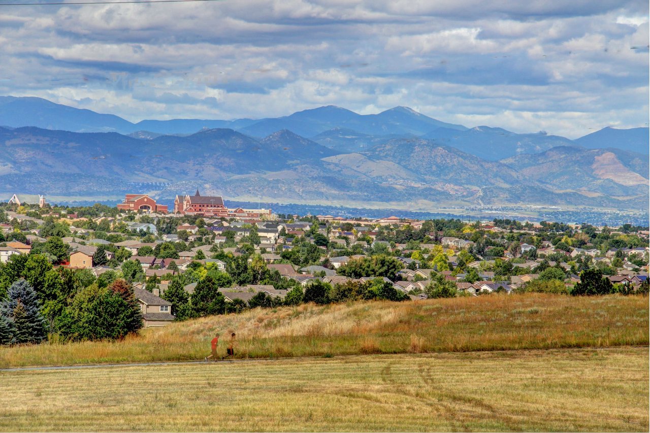 Aerial view of a densely packed city nestled between snow-capped mountains