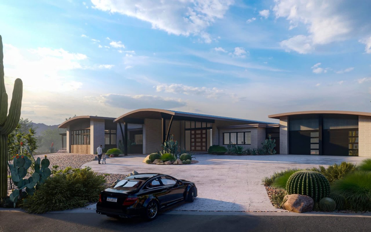 Modern desert home with curved rooflines, large windows, and a black luxury car parked in the driveway surrounded by cacti.