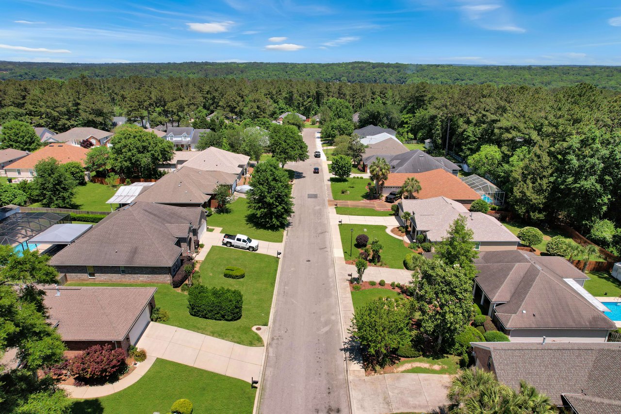 An aerial view of the Piney-Z neighborhood, showing houses, streets, and greenery.