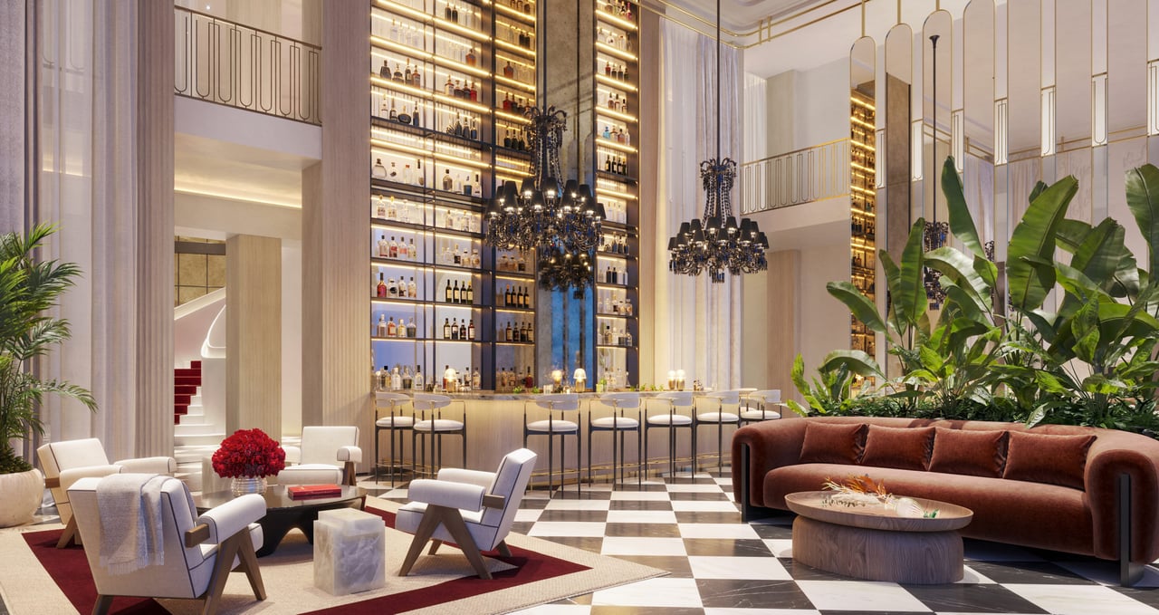 Luxury lobby with an illuminated bottle-lined bar, crystal chandeliers, and marble checkerboard flooring.
