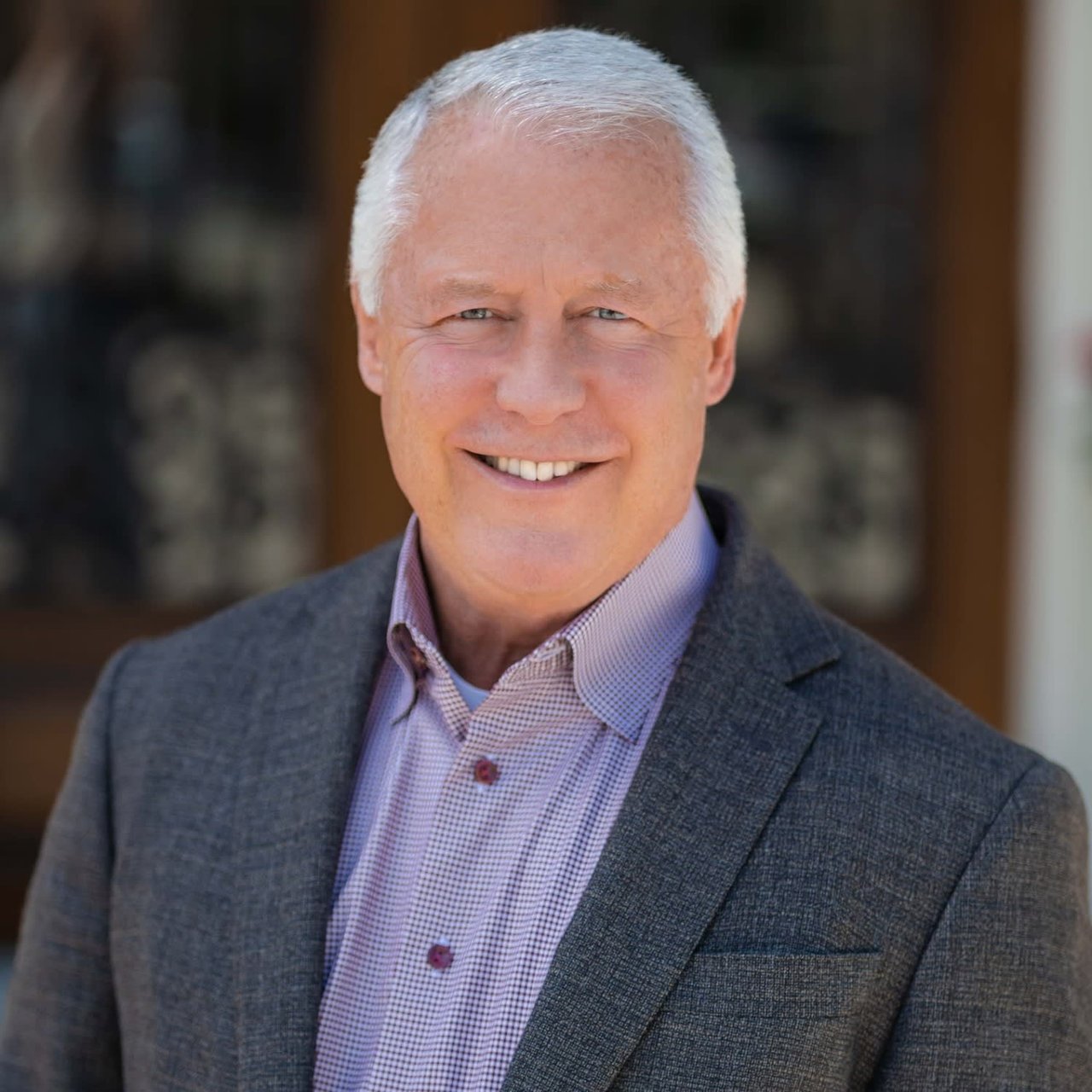 Mike Seder, a real estate professional from The Mike Seder Group, is dressed in a suit and has a smile on his face.