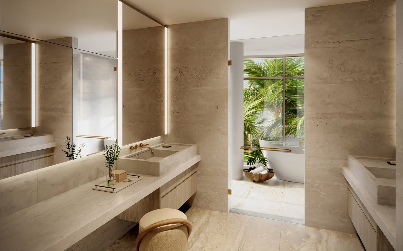 Luxury bathroom with a pale stone double vanity, illuminated mirrors, and palm trees visible through the window.