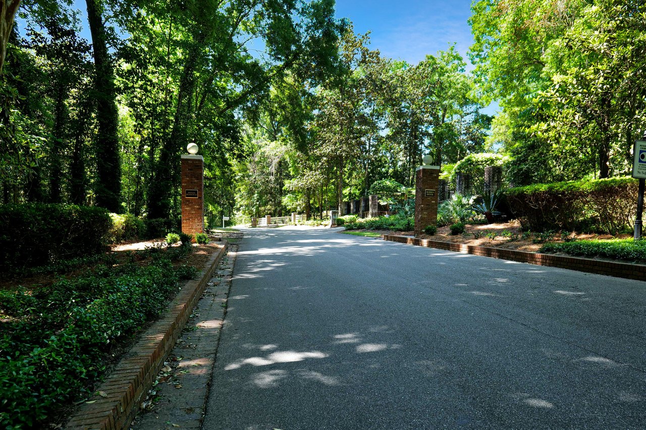 Another ground-level view of a street within Bobbin Brook, showing lush greenery and well-maintained roads.