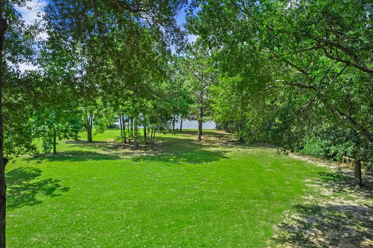 The 2.1 acre WATERFRONT lot is nicely wooded with mixed wood trees (Oaks and pines). 14 acre catch and release lake is in your backyard. Kayak, stand-up paddleboard, or fish without getting in your vehicle!