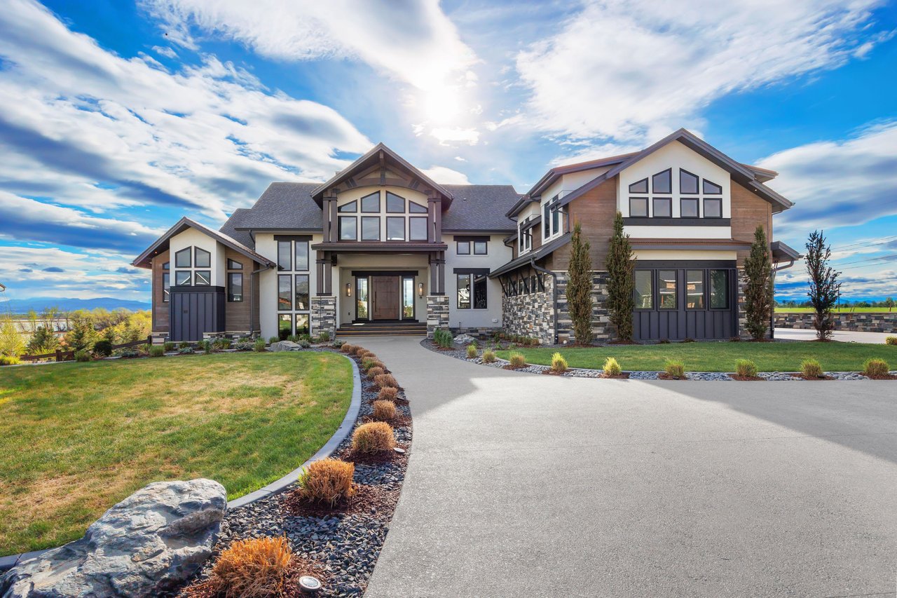 View of the front of a Modern Mountain luxury timber frame home in Timnath, Colorado sold by MCM Collective.