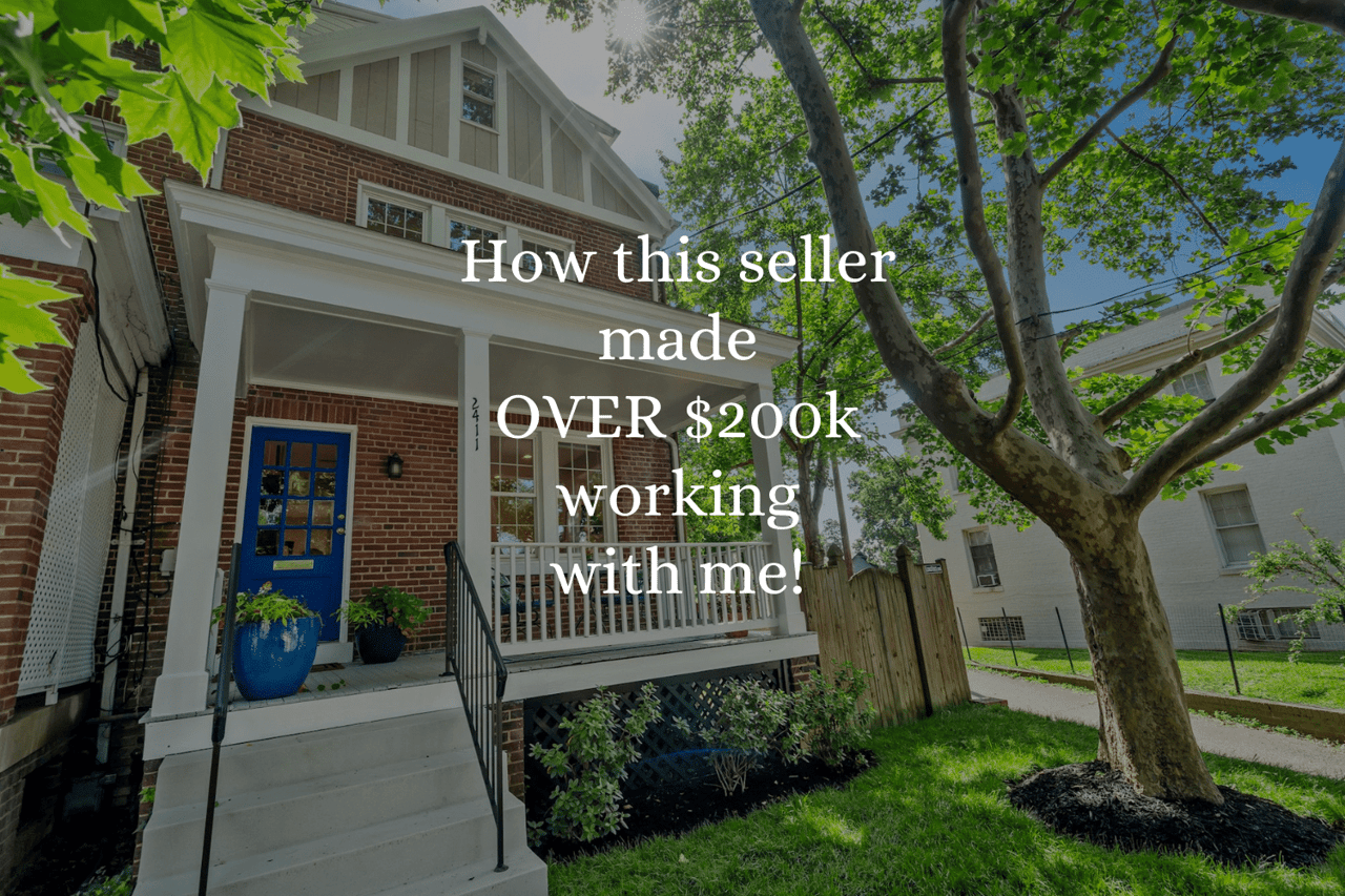 Brick house with a white-columned porch, bright blue front door, and large shade tree.