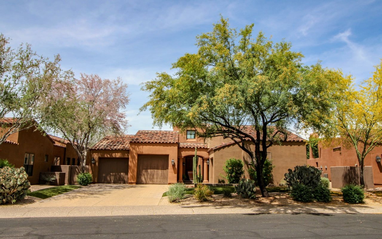 front view of a terracotta home with garage in rio rancho