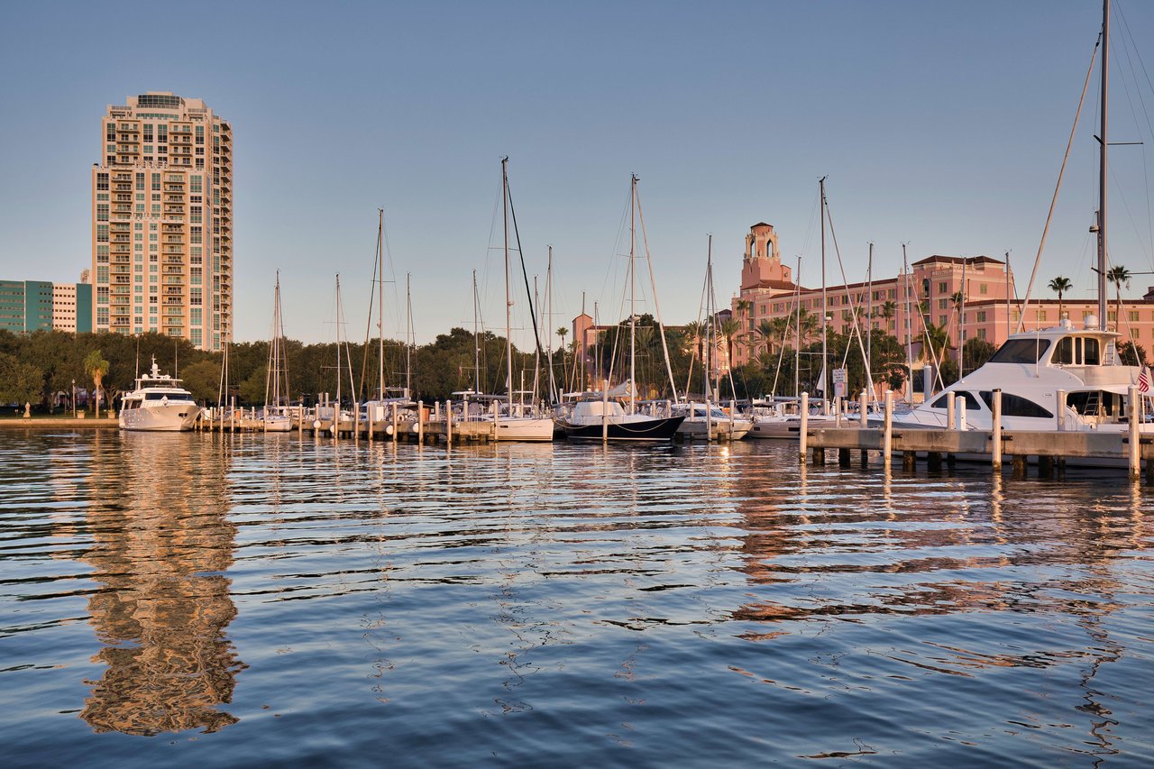 A vibrant shot of a marina captures several sailboats docked along a pier