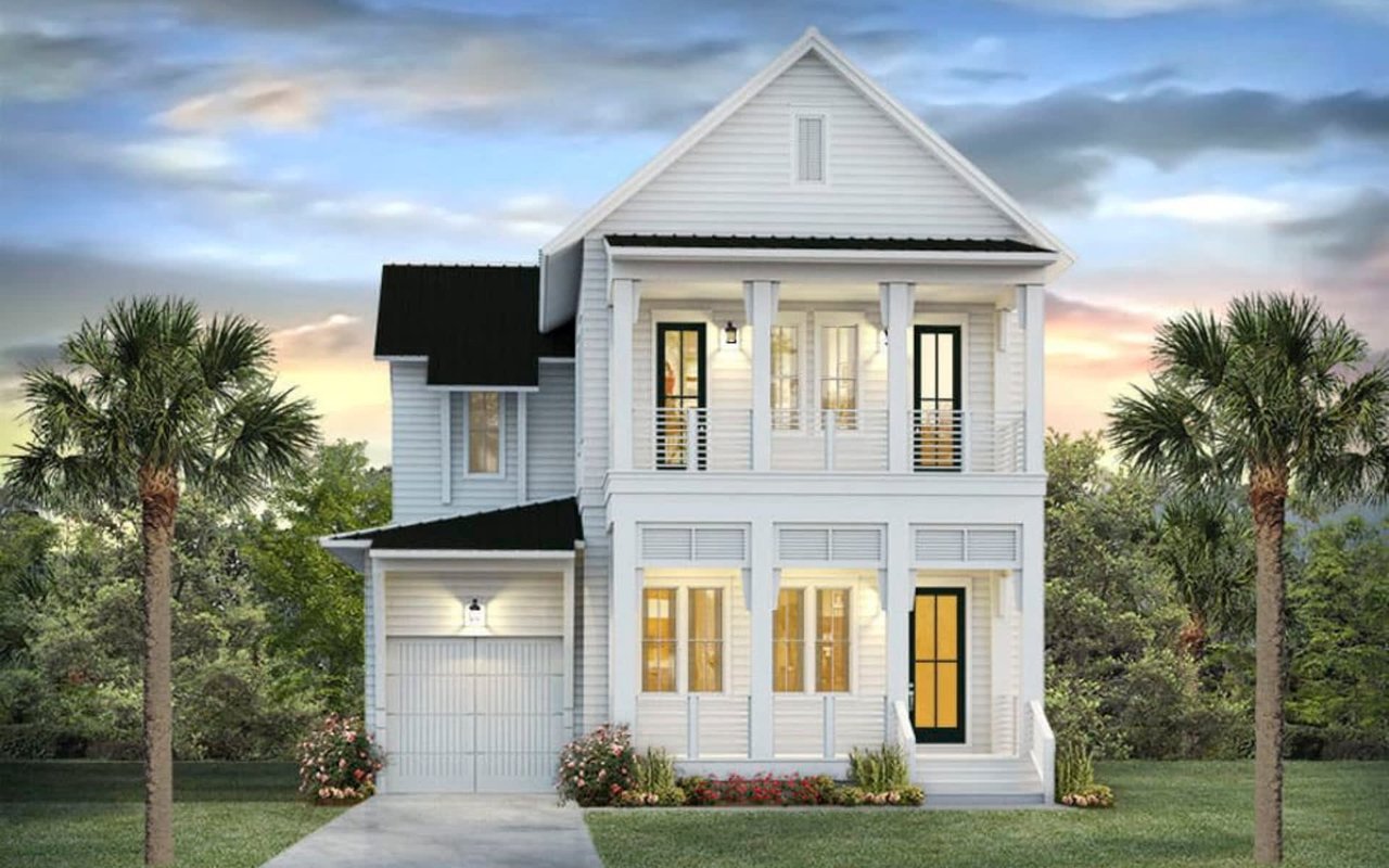 A two-story white farmhouse with a black roof and a front porch.