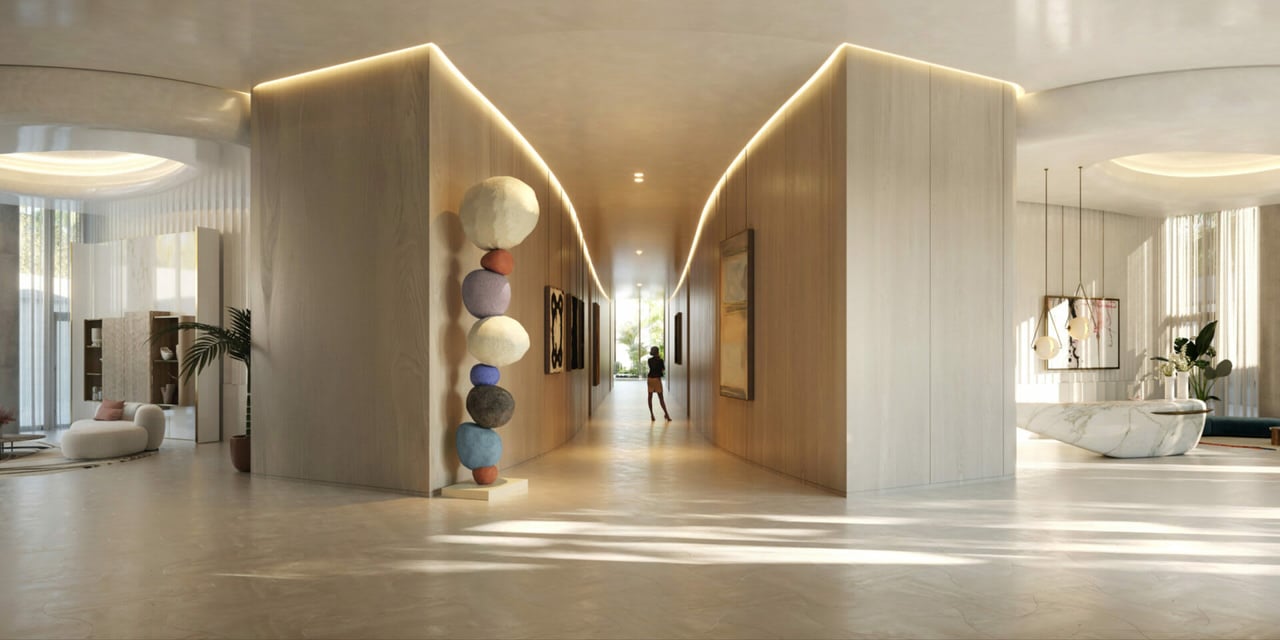Luxury residence lobby with a long illuminated hallway, sculptural stacked spheres, and lounge areas.