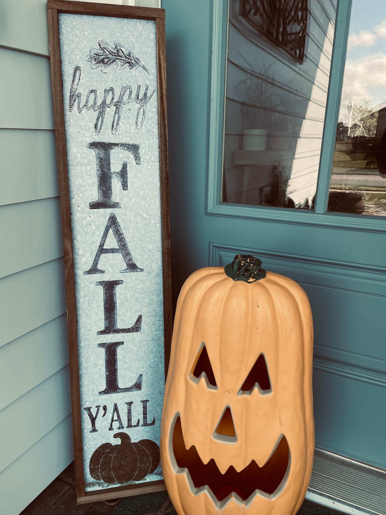 fall message and fake pumpkin near home door