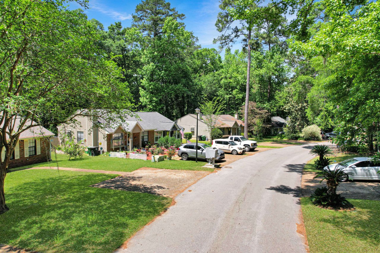 A street view in the Chases Ridge community, showing houses and a tree-lined street.