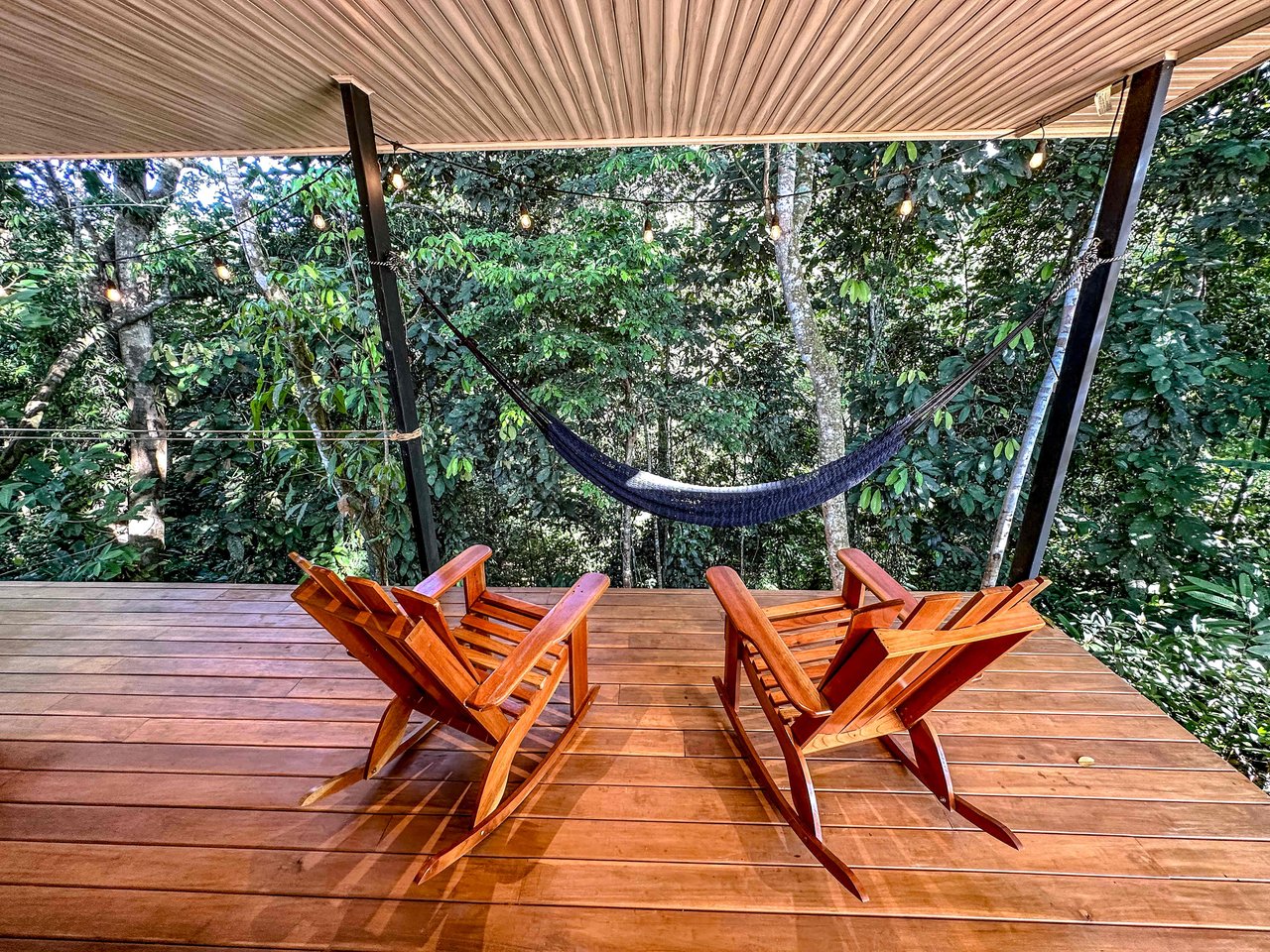 A 1-bedroom loft PERFECT for a couple or an Airbnb rental – plus a HUGE jungle backyard with a year-round river and many magical swimming holes – and a lot of flat land for further development!