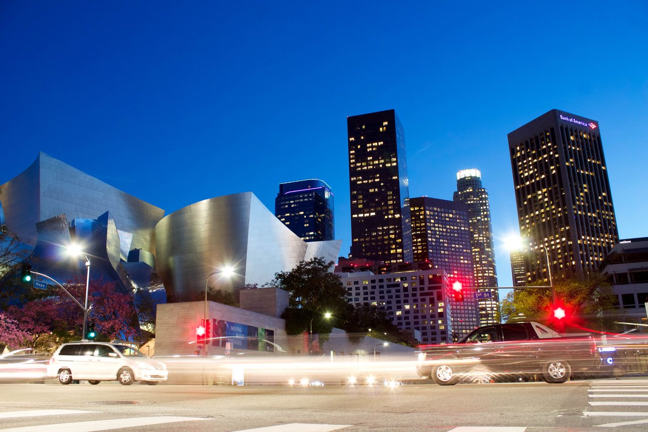 Downtown Los Angeles at dusk, with the Walt Disney Concert Hall and illuminated skyline.