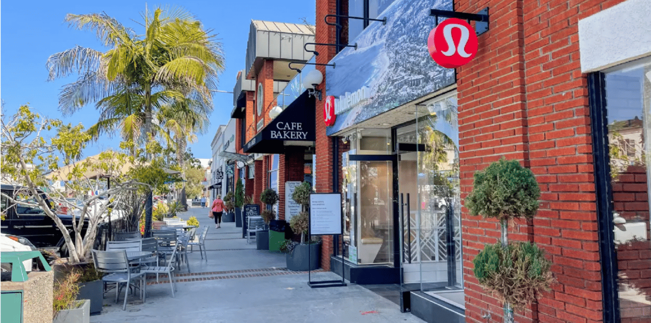 Cafe bakery and restaurants along the street of the Village of La Jolla with tree lines