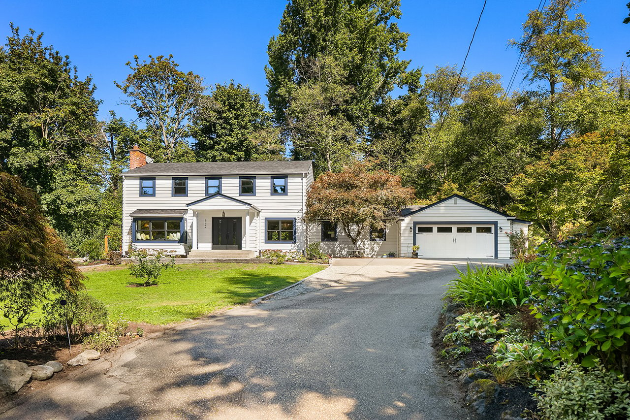 front view of normandy park home with trees and driveway