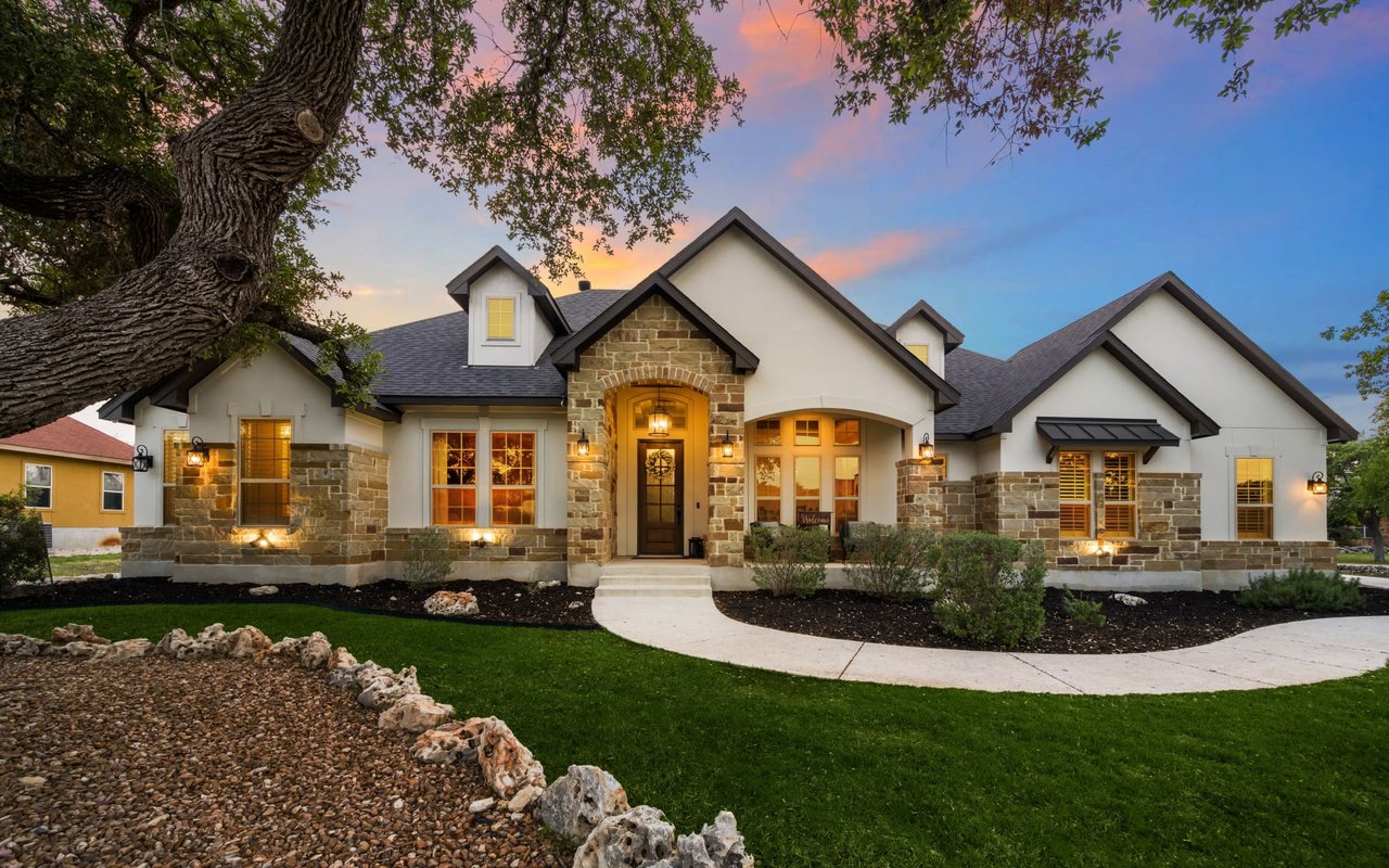 Beautiful house with a lush garden under pleasant weather, exemplifying Round Rock real estate