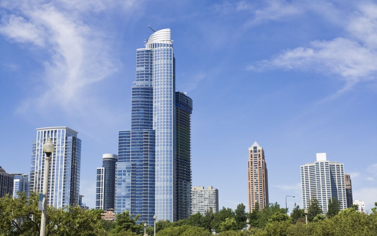 A row of diverse, tall skyscrapers in Chicago, featuring the distinct One Museum Park residential building on the left.