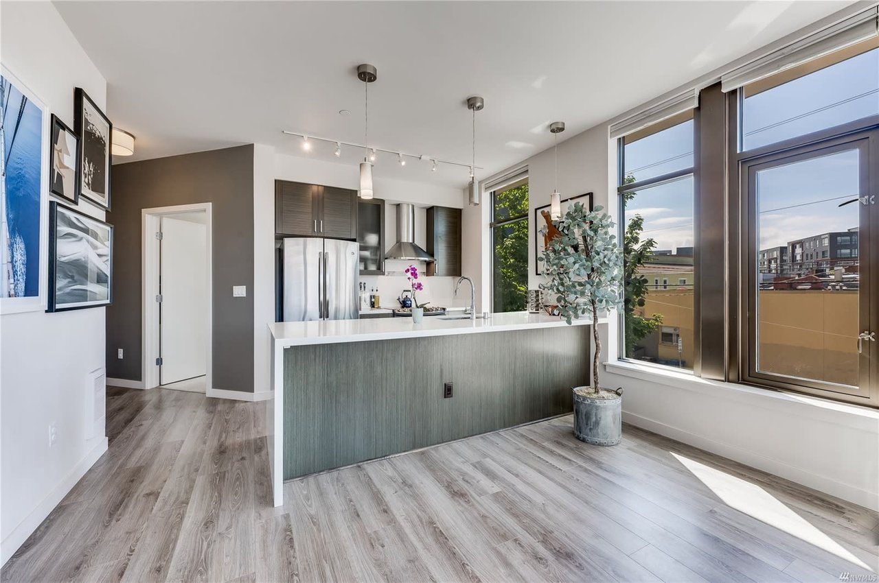 Sleek condo kitchen with contemporary design and cityscape views, embodying modern urban elegance.