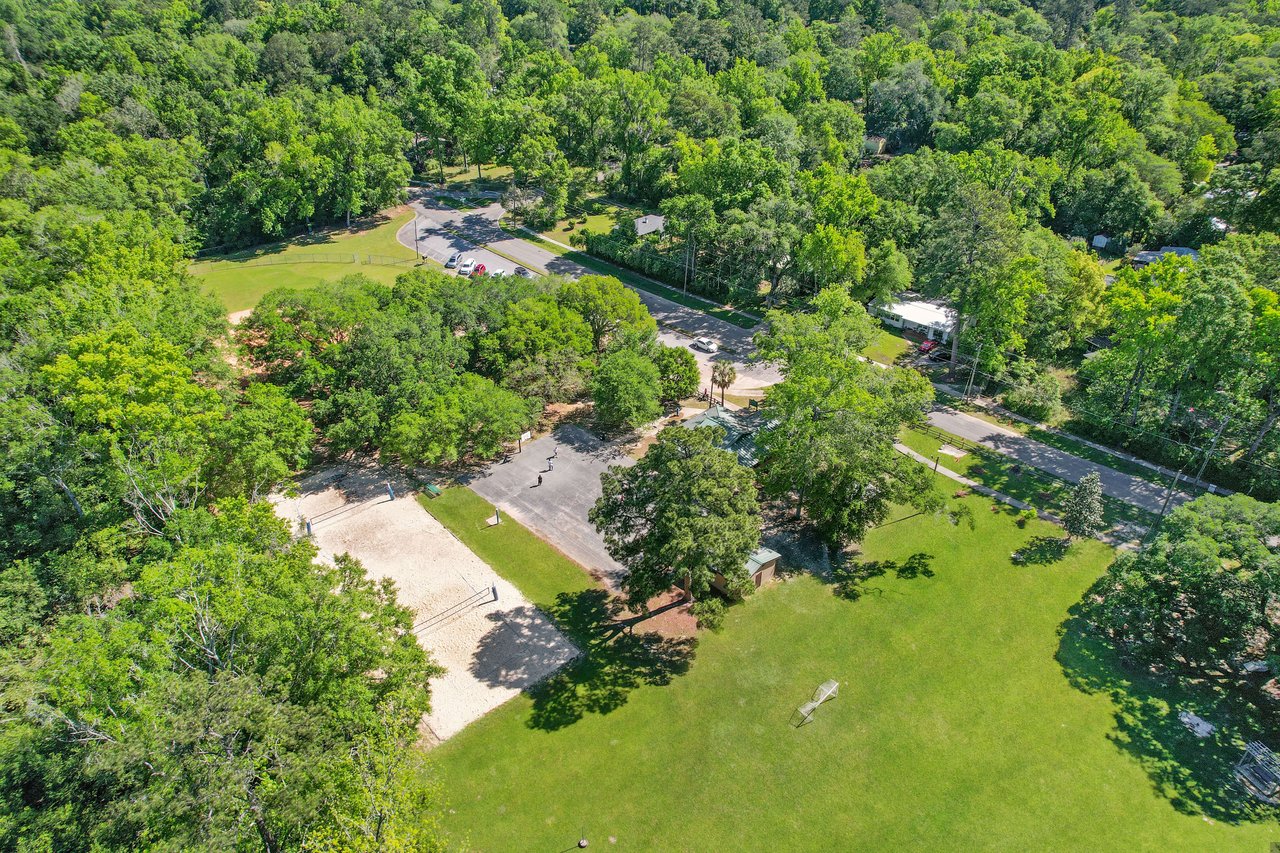 An aerial view focusing on a specific area within the Indian Head neighborhood, showcasing houses, green spaces, and trees.