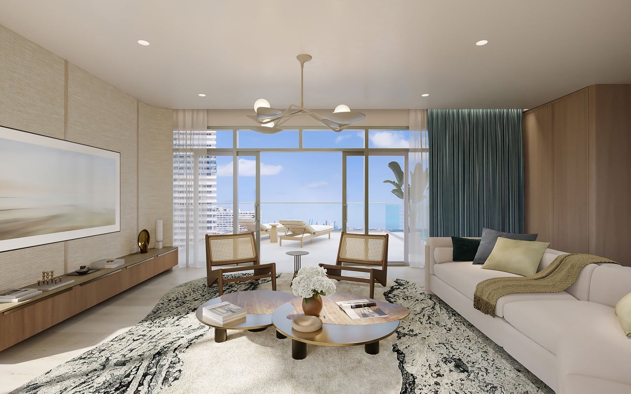 Furnished condo living room with a white sectional, balcony, and water and city views.