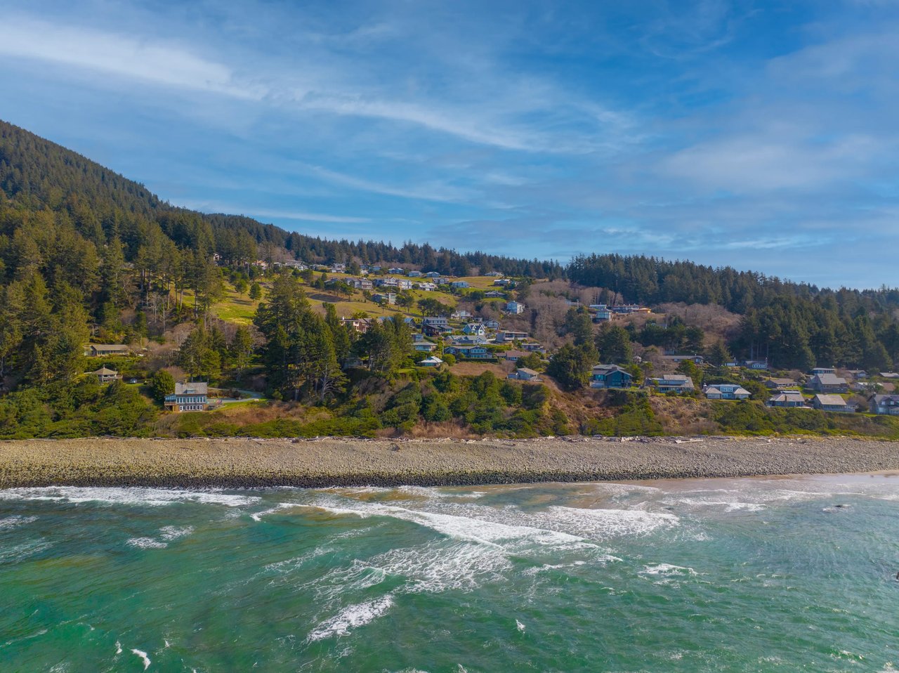 homes on the side of neakahnie mountain viewed from the ocean