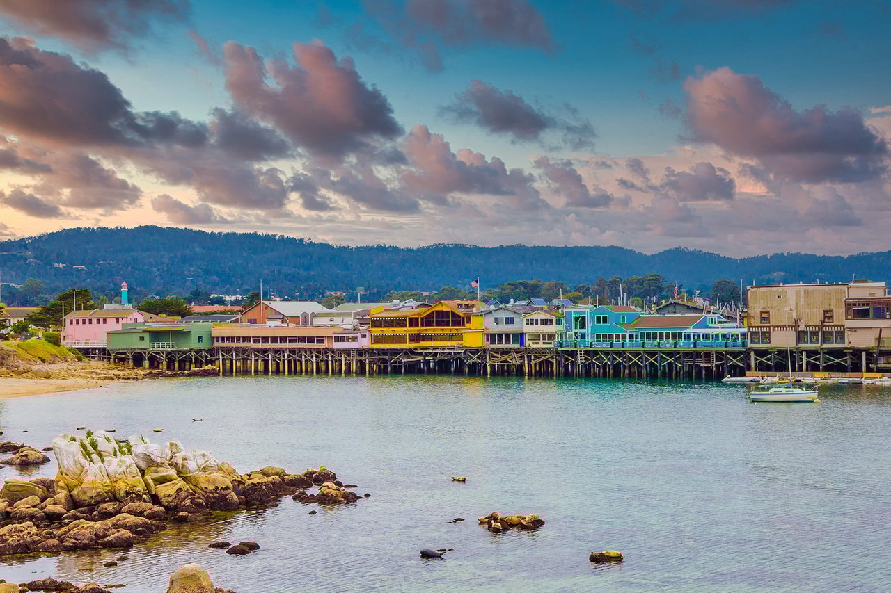 a pier with colorful buildings and a boat in the water