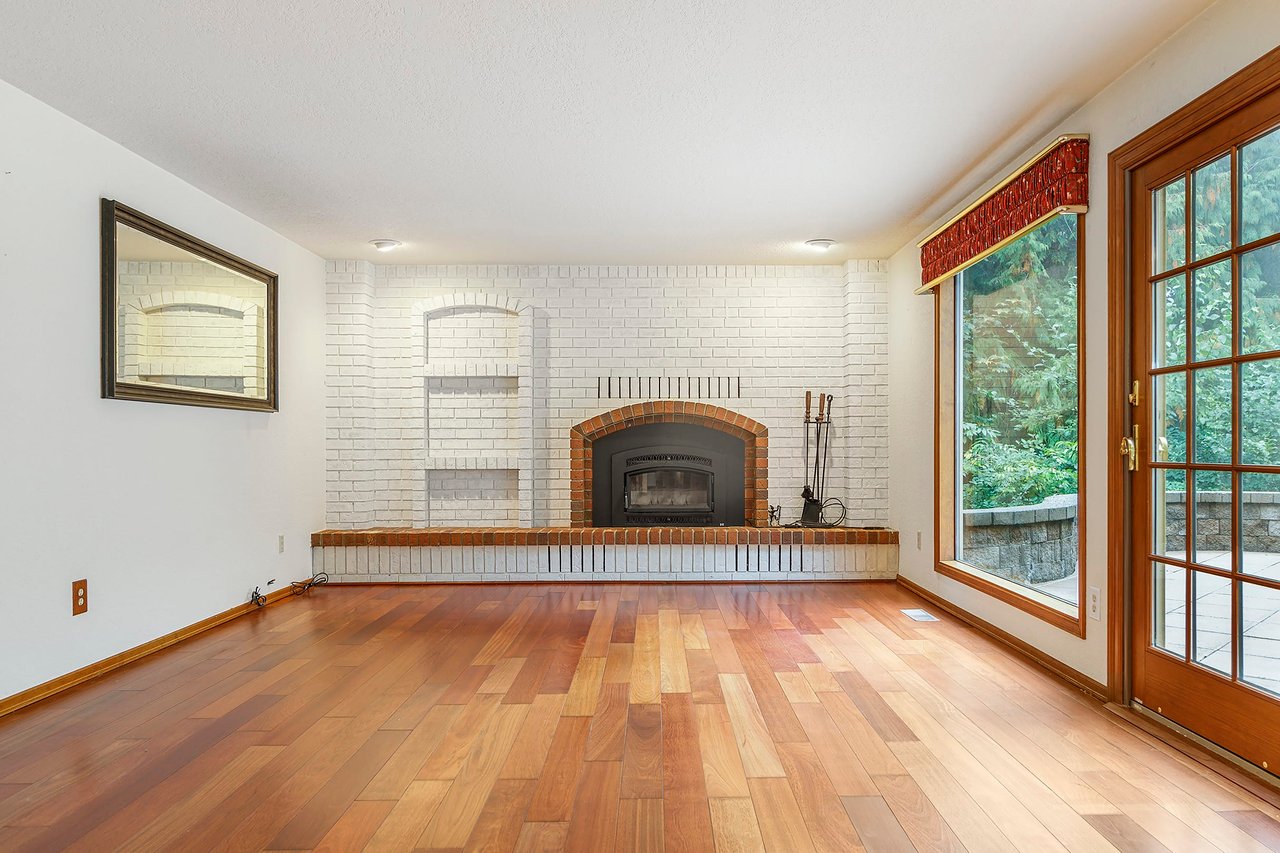 Take a moment to admire the meticulous attention to detail in the brick wall fireplace, complete with built-in shelves. It's a beautiful focal point that adds both style and functionality to the family room.