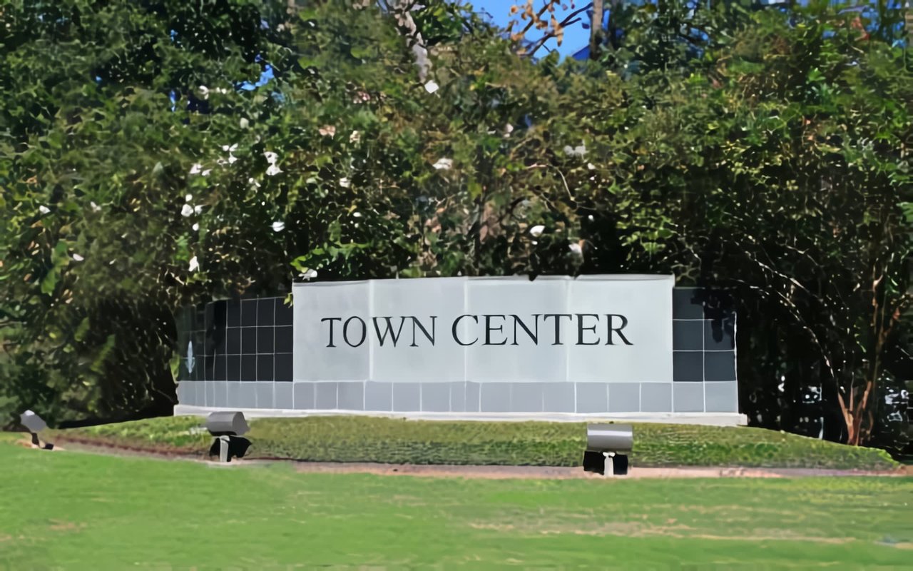 The background is filled with dense green trees and foliage, suggesting a natural and well-maintained area. 