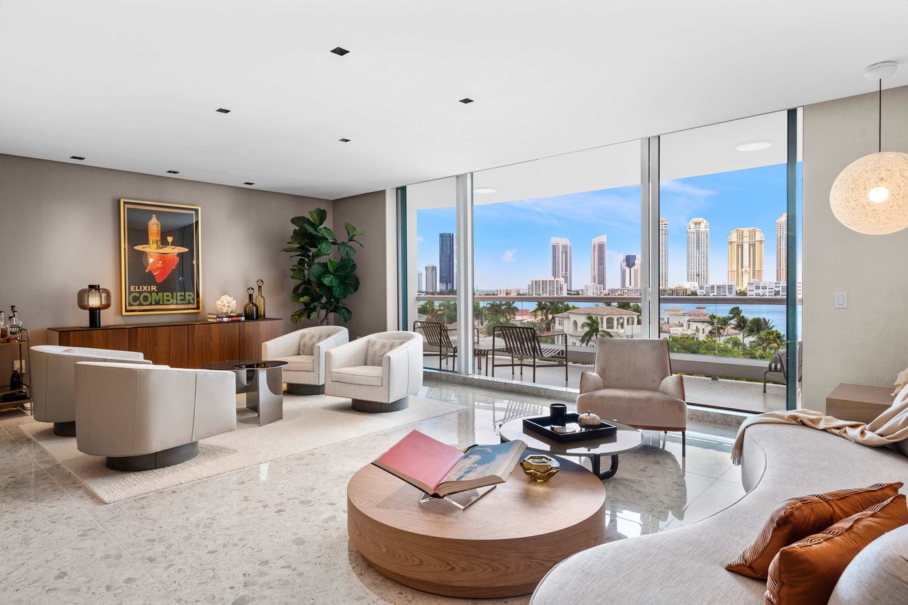 Modern living room with gray tones, large windows, intercostal view, plush seating, round coffee table, and contemporary decor accents.