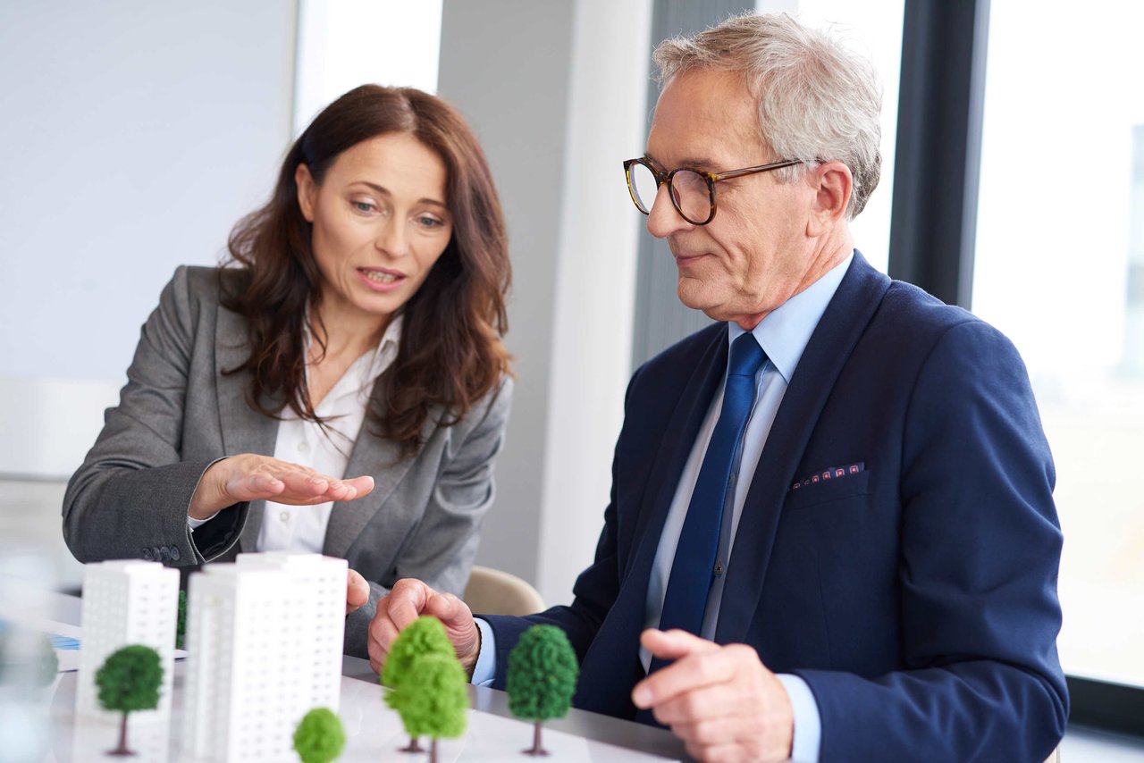 couple looking on real estate property model