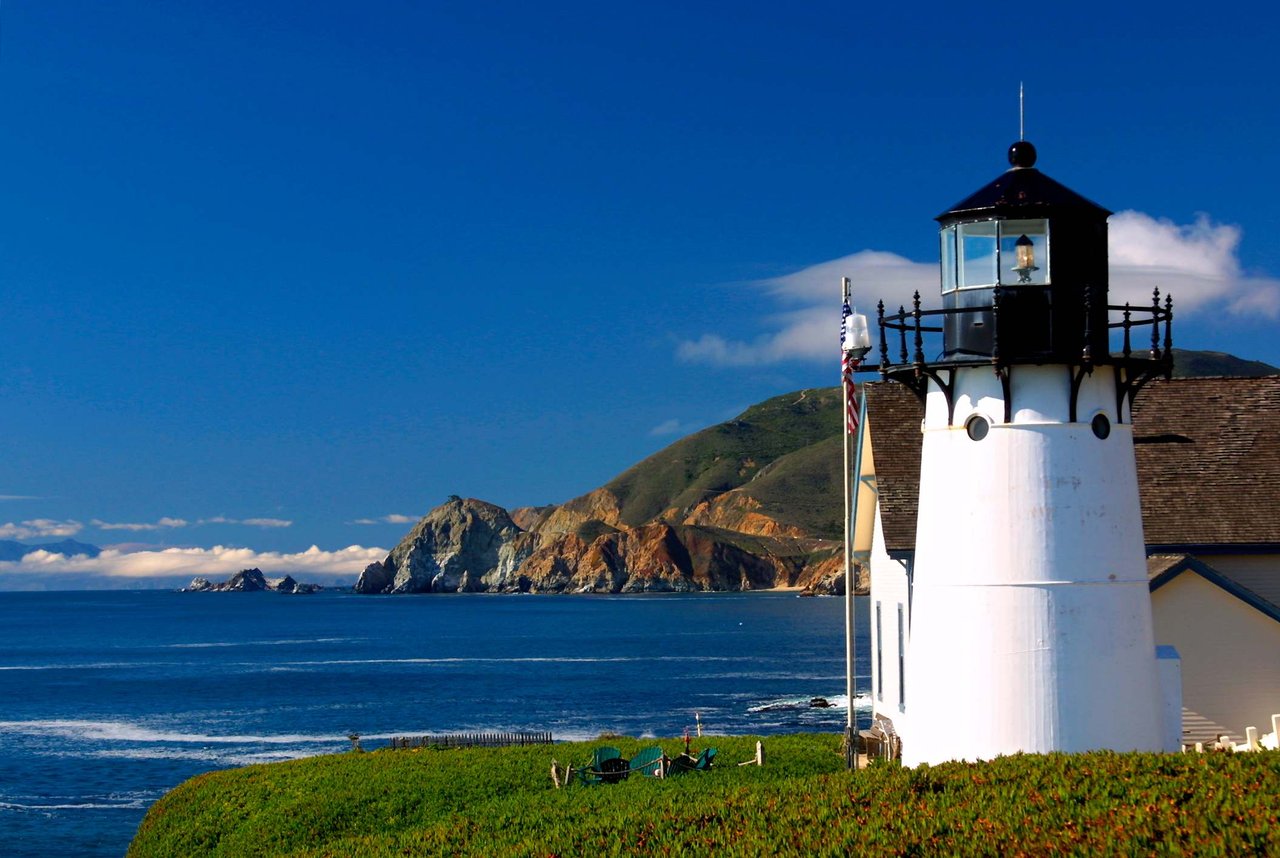Point Montara Lighthouse overlooking the Pacific Ocean with rugged coastal cliffs and clear blue skies in Montara, California on the San Mateo County Coastside.