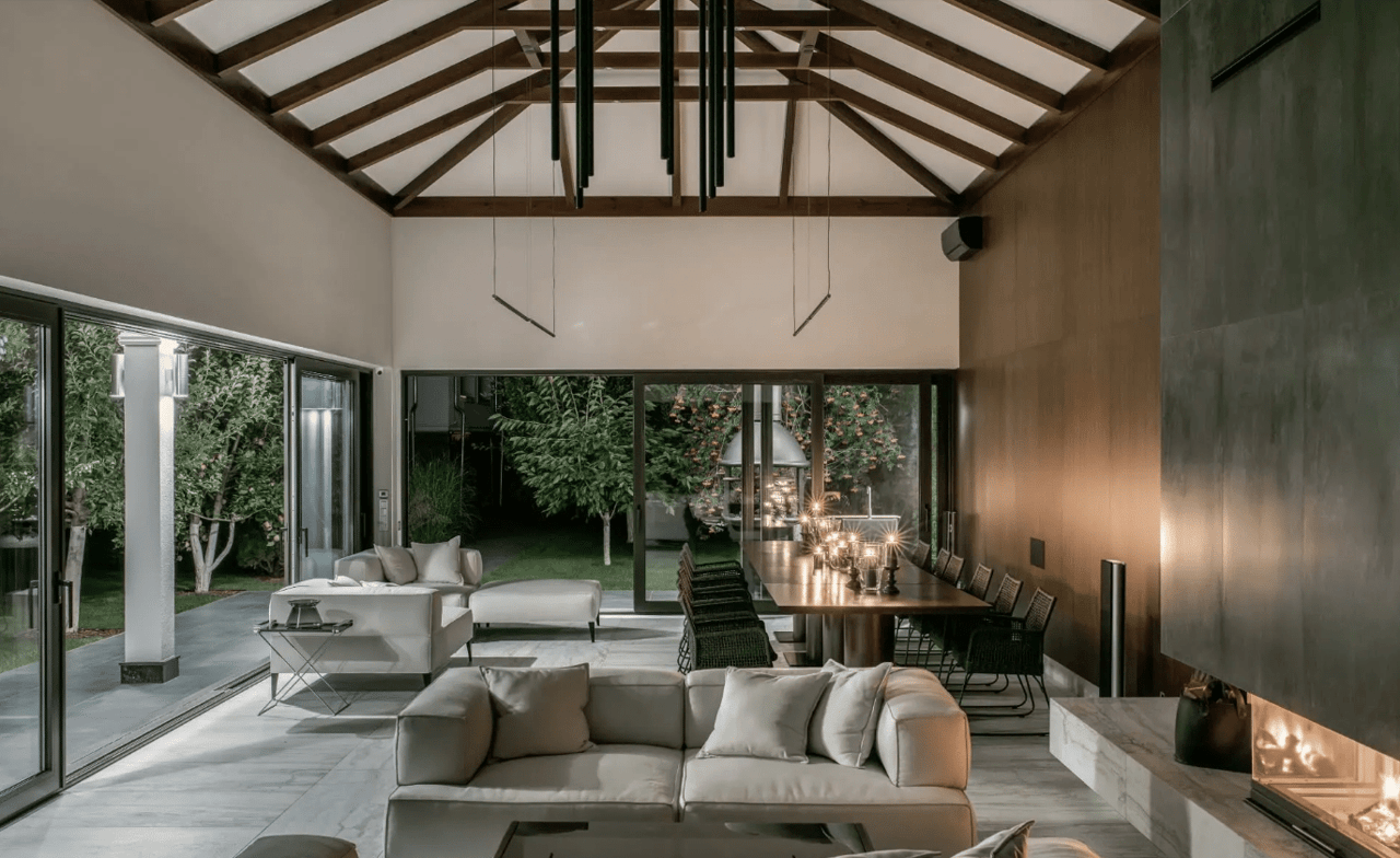 A living room with a fireplace, a couch, a fireplace and a table