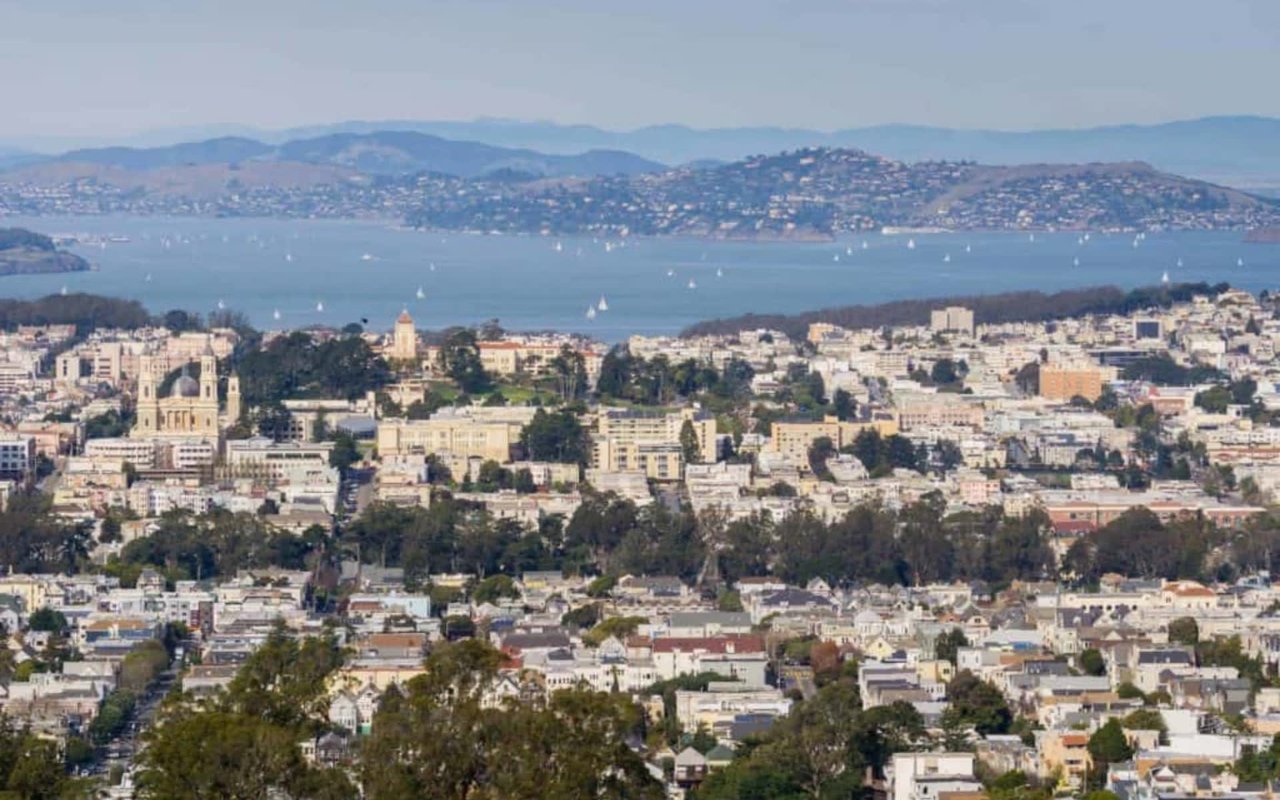 Pacific Heights rooftops overlook San Francisco Bay and the hills beyond.