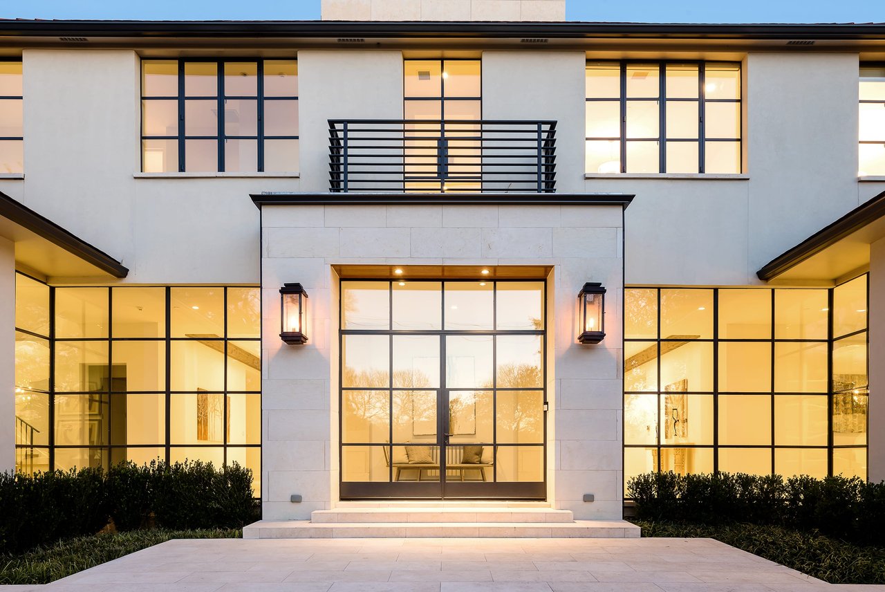 An exterior view of a modern home featuring large windows that allow for an abundance of natural light to brighten the interior spaces.